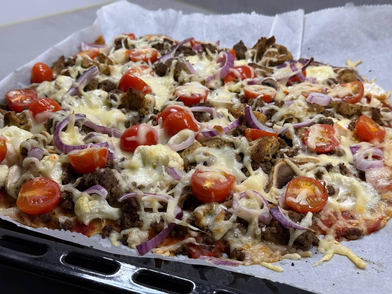 High-protein pizza slice with a generous topping